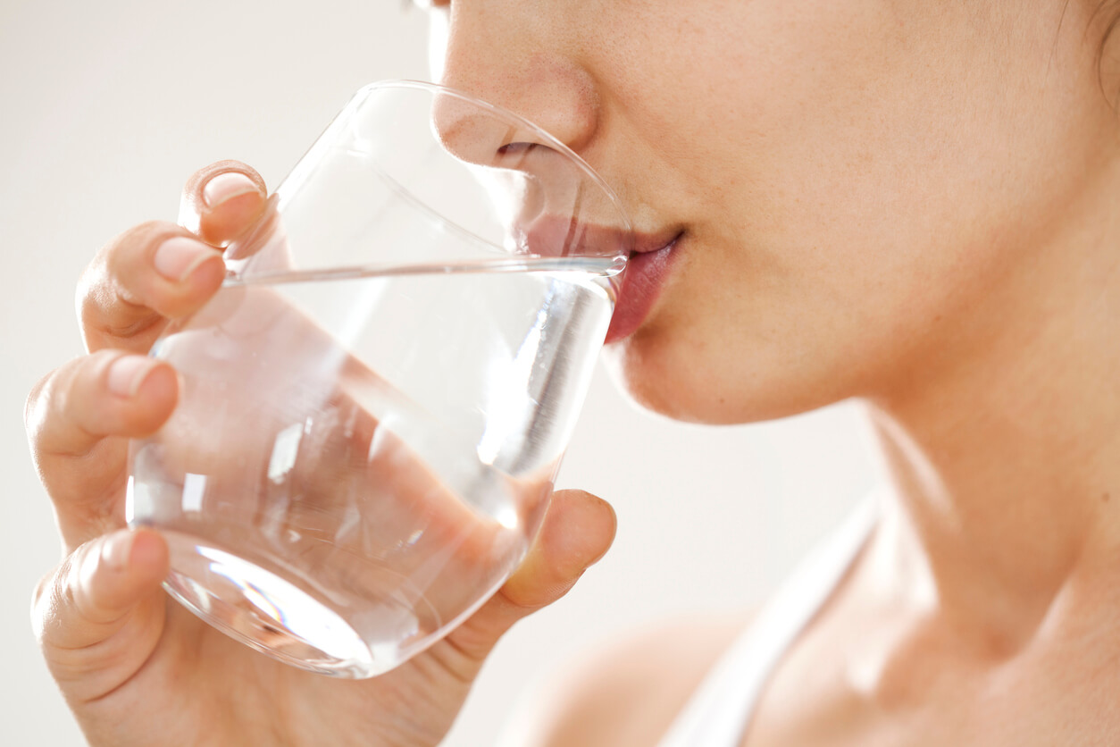 young woman drinking glass of water